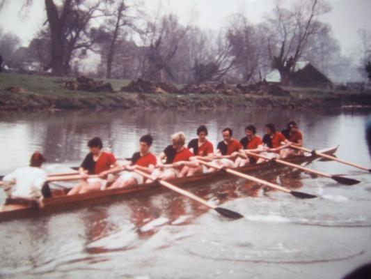 Colour photo of the First crew on the river in black and redrowing gear.