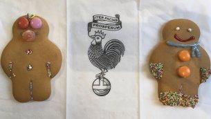 Triptych of two gingerbread men flanking the College rebus