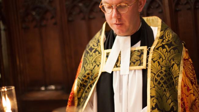 Image of The Dean reads during evensong