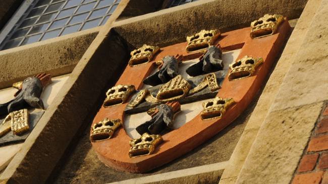 Image of A close up of a Jesus College crest on a building