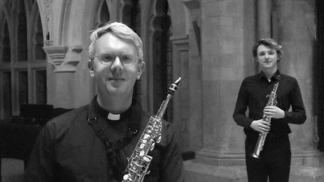 Image of A black and white photo of two people holding saxophones