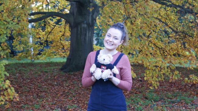 Image of Orla holding the College teddy bear