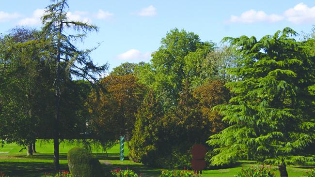 Image of Jesus College gardens with a horse sculpture in the foreground
