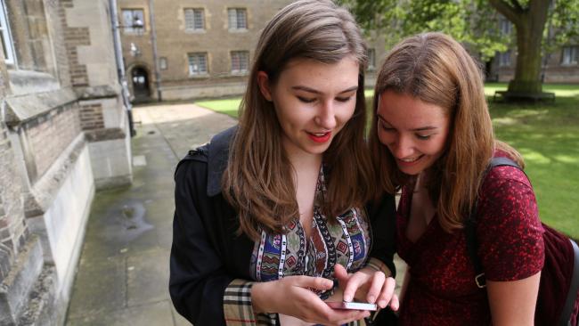 Image of Young women look at a mobile phone