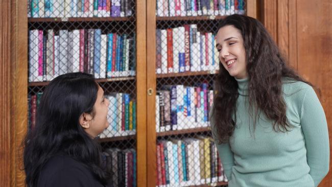 Image of Postgraduate students talking in the Webb Library