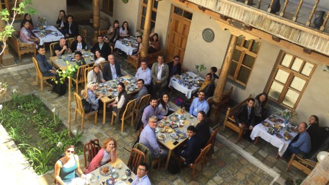 Image of Group of people at an outdoor restaurant in Central Asia, looking at the camera