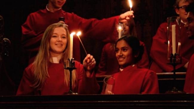 Choir singers lighting candles