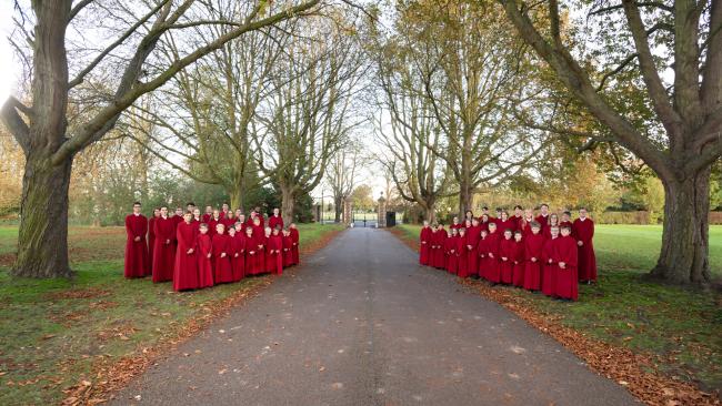 Combined choirs standing either side of driveway