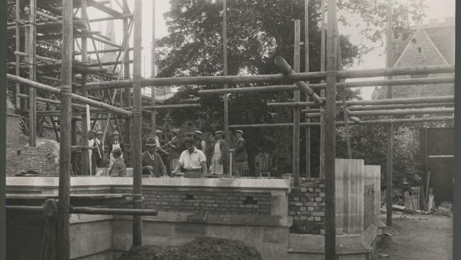 P.R Morley Horder supervises building works. Chapel Court 1929