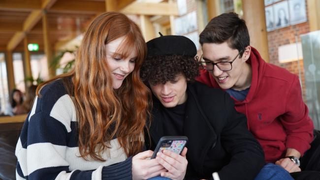 Students looking at a phone