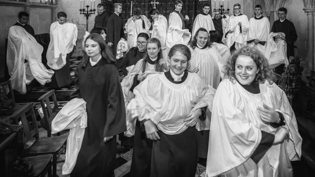 Choir members starting to take off their surplices at the end of a service in the Chapel
