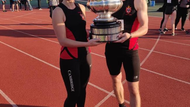 Cara James and Ollie Brown hold the cup