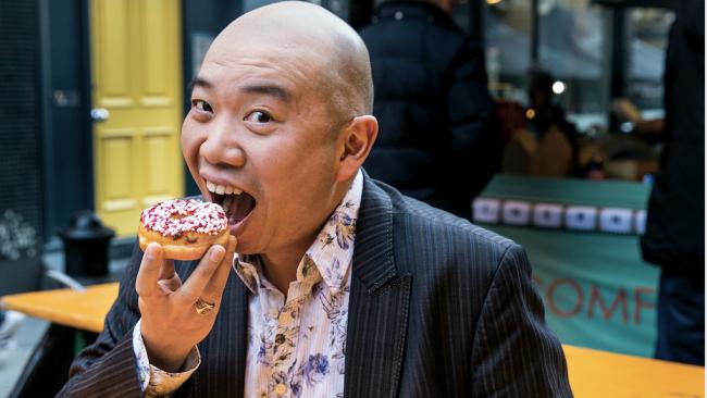 Giles Yeo eating a doughnut 
