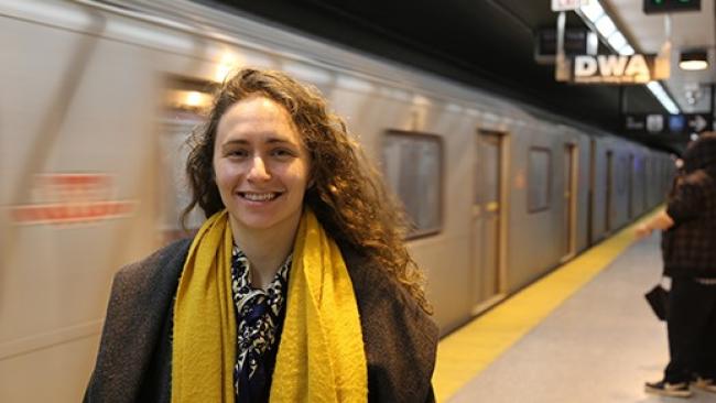 Professor Shoshanna Saxe standing in front of an underground train