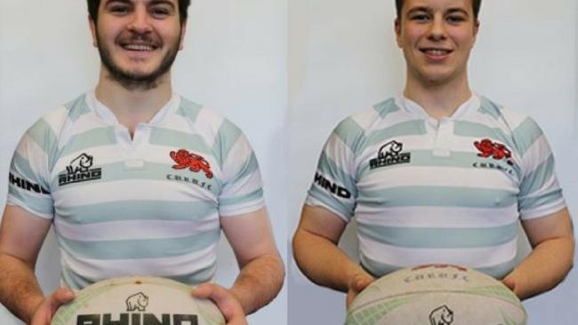 Two rugby players side by side both holding a rugby ball