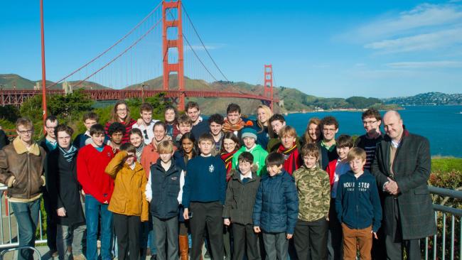 Choir standing in front of the Golden Gate Bridge